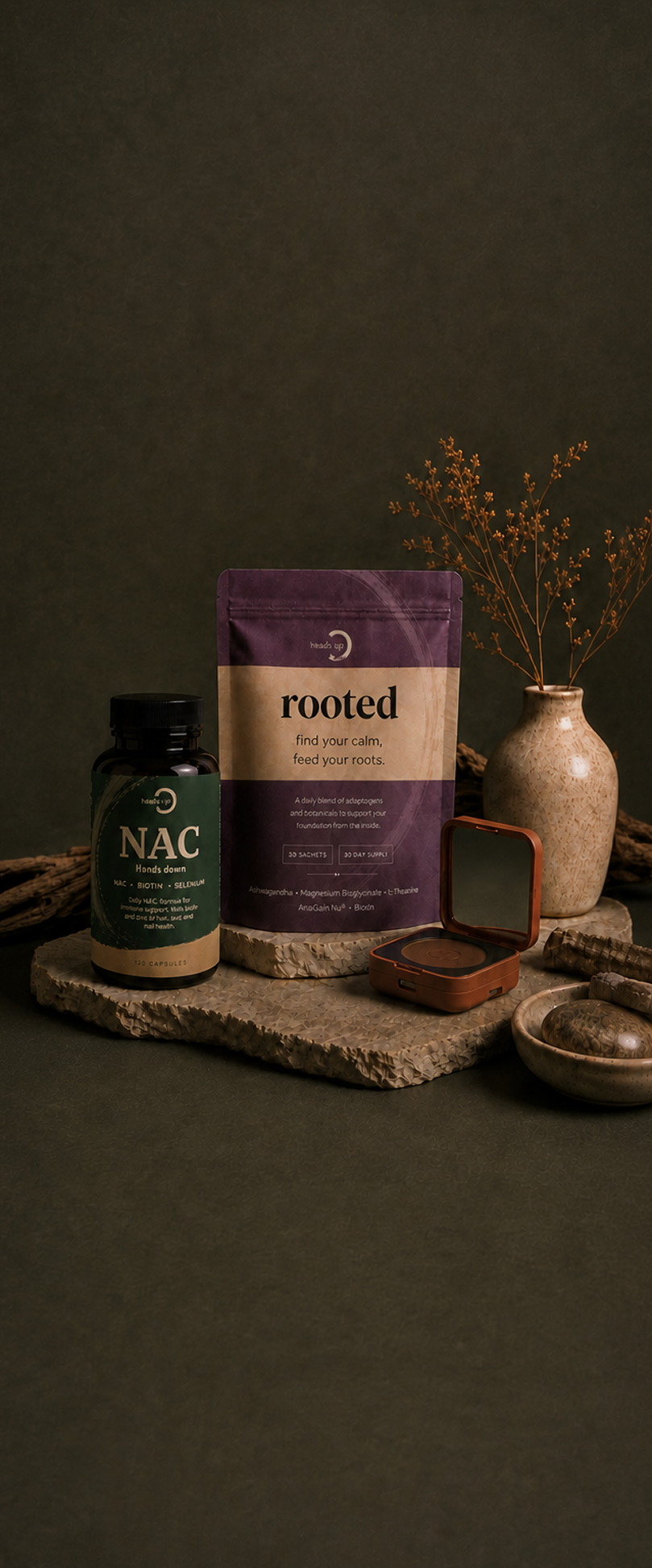 Hands Down NAC bottle, Rooted pouch and compact powder on textured stone