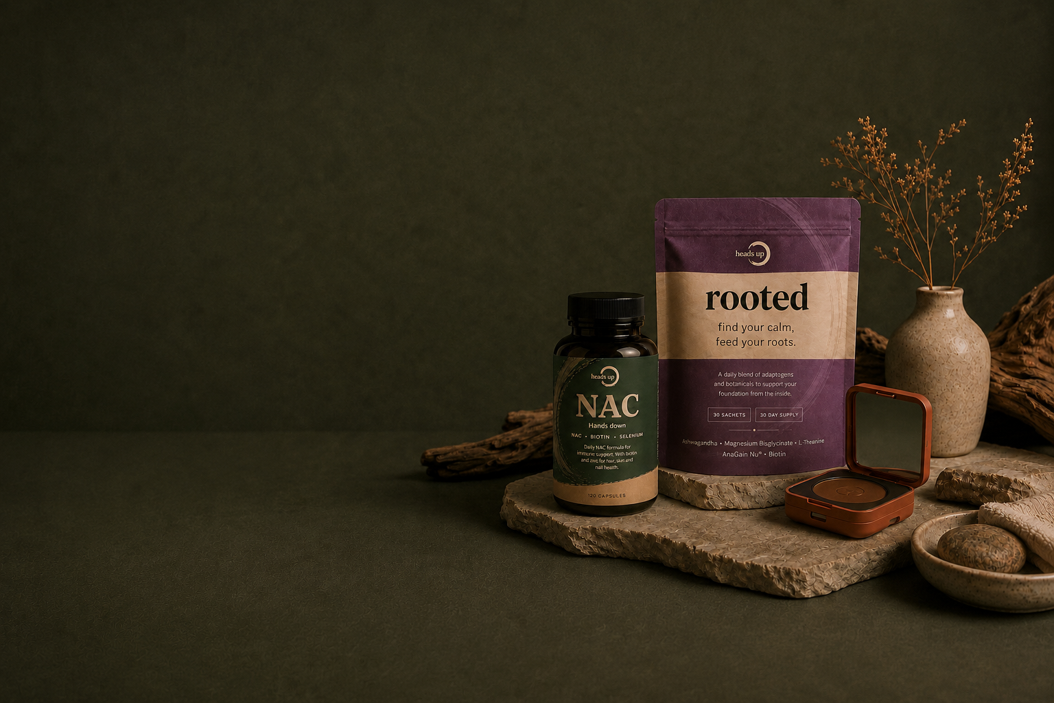 Hands Down NAC bottle, Rooted pouch and compact powder on textured stone